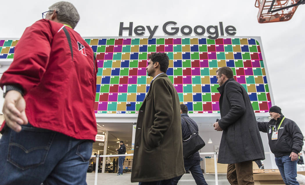 Visitors walk past Google's promotional space outside the Las Vegas Convention Center on the eve of opening day of CES 2019 on Monday, Jan. 7, 2019, in Las Vegas. The four day tech event brings ov ...