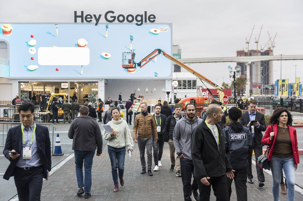 Visitors walk past Google's promotional space outside the Las Vegas Convention Center on the eve of opening day of CES 2019 on Monday, Jan. 7, 2019, in Las Vegas. The four day tech event brings ov ...