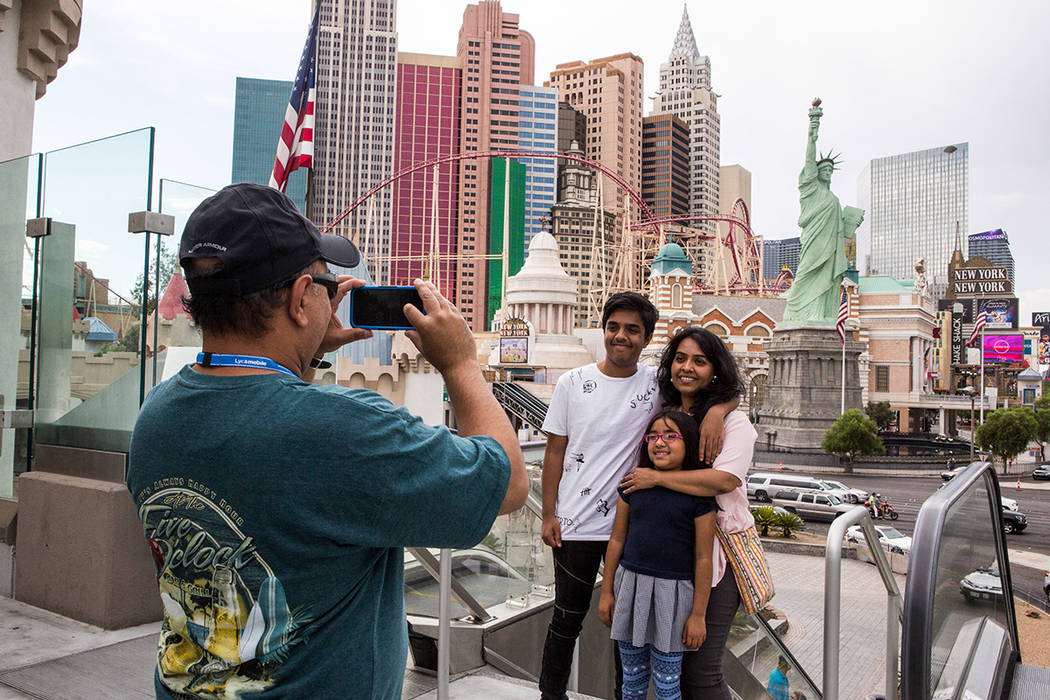 Ashish Mehta takes a photo of his wife Ami and children Arnav, 14, and Veda, 7, on the Las Vegas Strip. The family was visiting from Illinois. Patrick Connolly/ Las Vegas Review-Journal