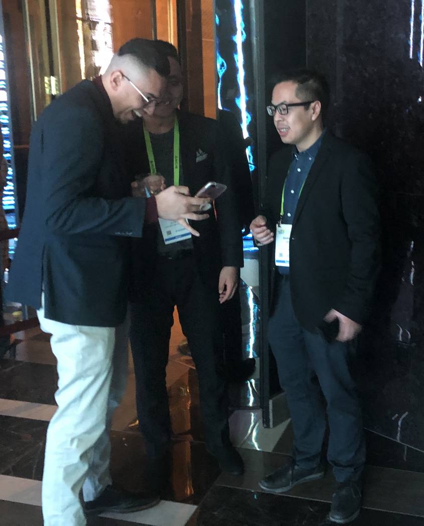 Conventioneers Rinzi Sheka, left, and Darryl Lee of Calgary look over photos they took durin the CES 2019 C Space Party presented by Jewel Nightclub at Aria in Las Vegas Monday, Jan. 7, 2019. John ...