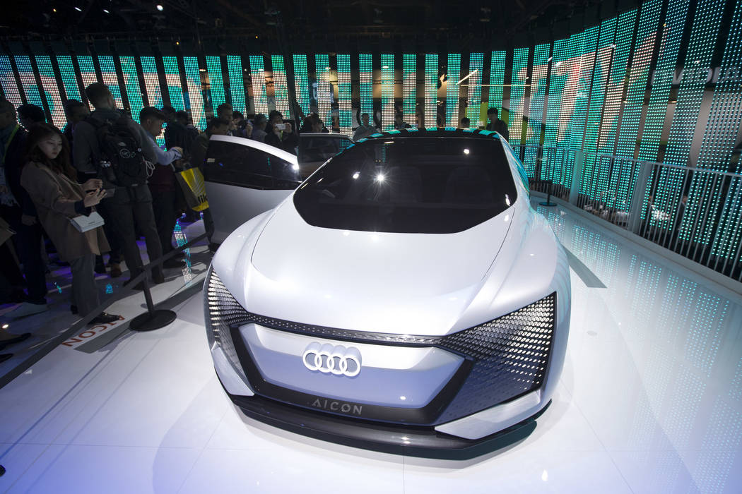 Attendees browse over the Audi Aicon, a fully autonomous concept car due out in 2021, on display on day one of CES at the Las Vegas Convention Center in Las Vegas on Tuesday, Jan. 8, 2019. Richard ...