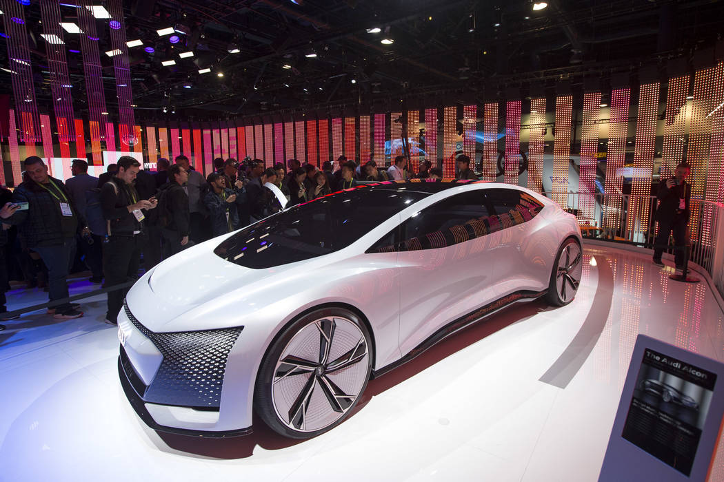 Attendees browse over the Audi Aicon, a fully autonomous concept car due out in 2021, on display on day one of CES at the Las Vegas Convention Center in Las Vegas on Tuesday, Jan. 8, 2019. Richard ...