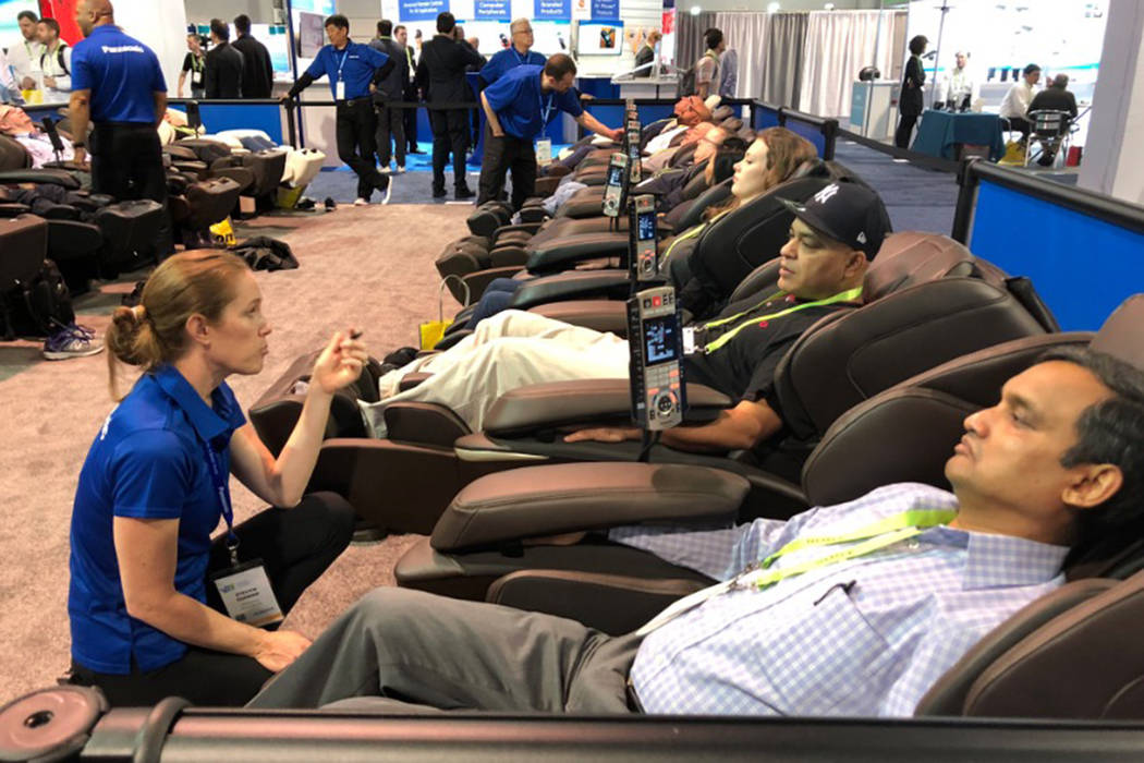 Rows of CES goers enjoy the Panasonic Real Pro Ultra massage chair in Las Vegas on Tuesday, Jan. 8, 2019. (Benjamin Hager/Las Vegas Review-Journal)
