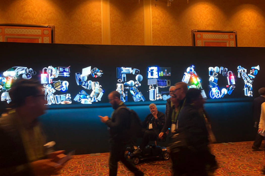 Attendees of CES in Las Vegas walk past a sign on Tuesday, Jan. 8, 2019. (Caroline Brehman/Las Vegas Review-Journal)