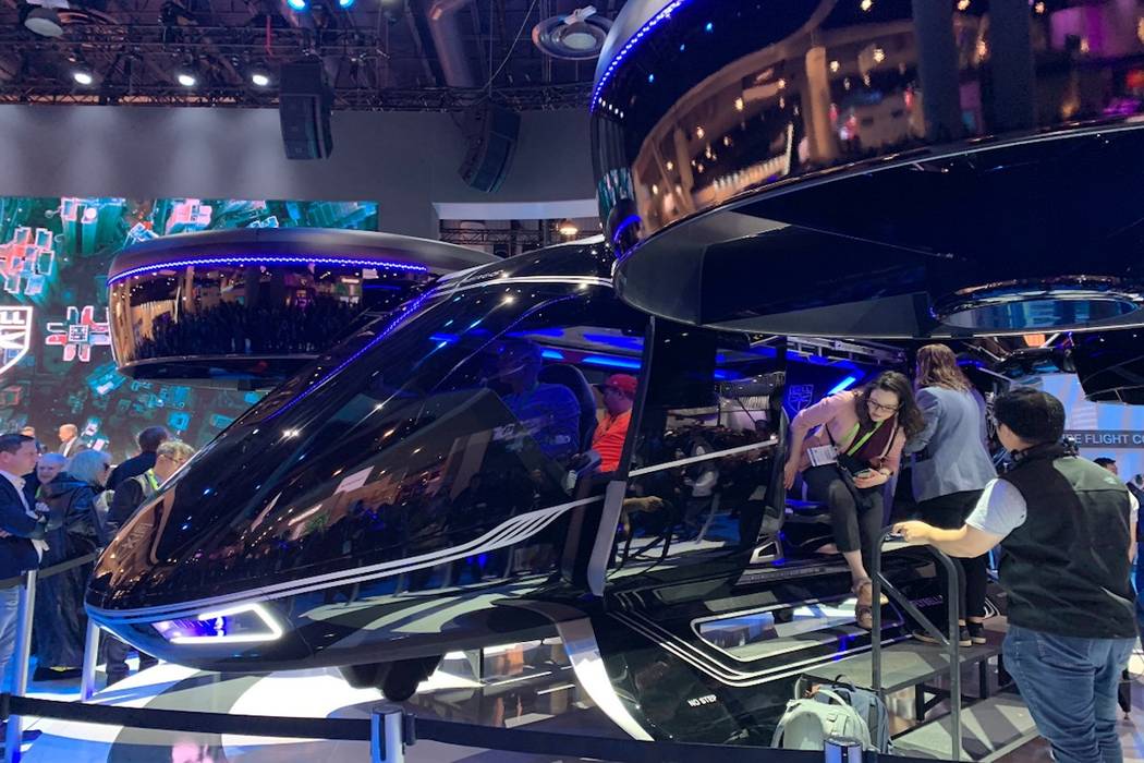 CES attendees look at a model of Bell’s “flying taxi” that Uber plans to have in the air in Los Angeles, Dallas and an international city in 2020 for testing purposes and 2023 commercially. ...