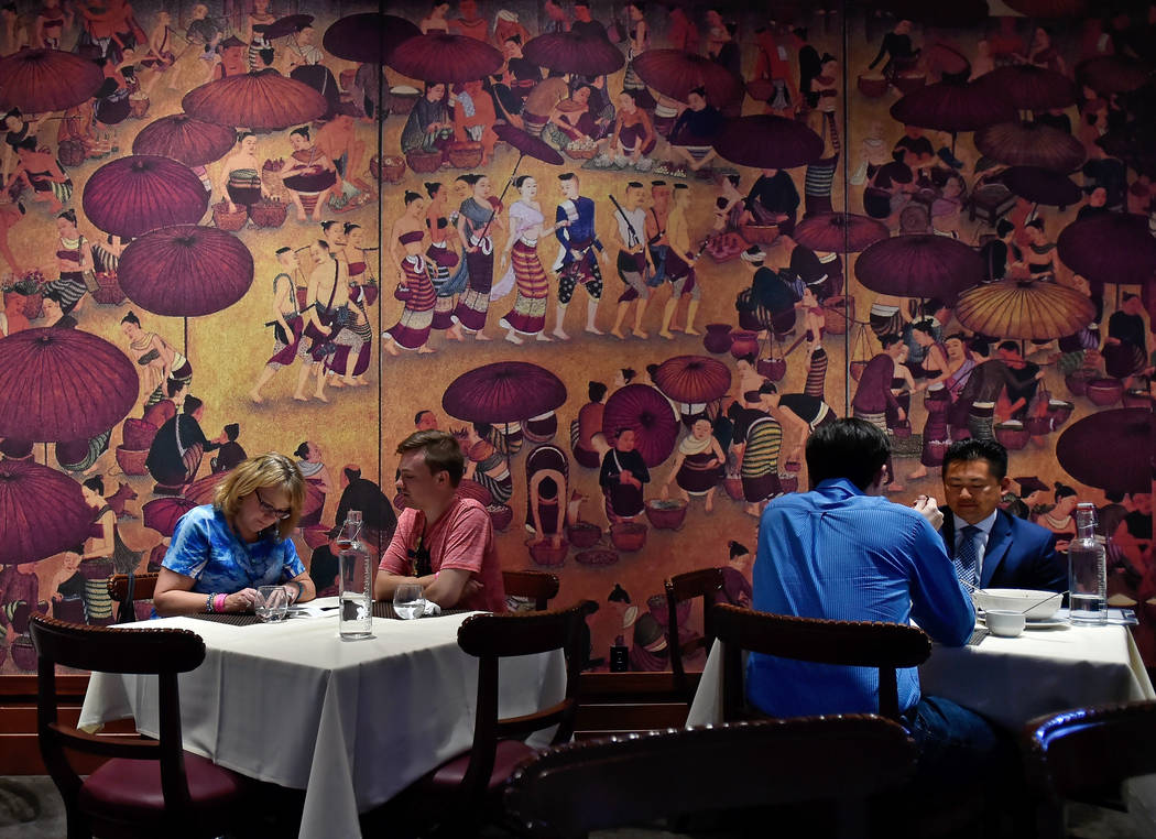 Diners sit in front of one of the many murals that decorate the dinning room at Lotus of Siam restaurant Friday, May 11, 2018, in Las Vegas. (David Becker/Las Vegas Review-Journal) @davidjaybecker