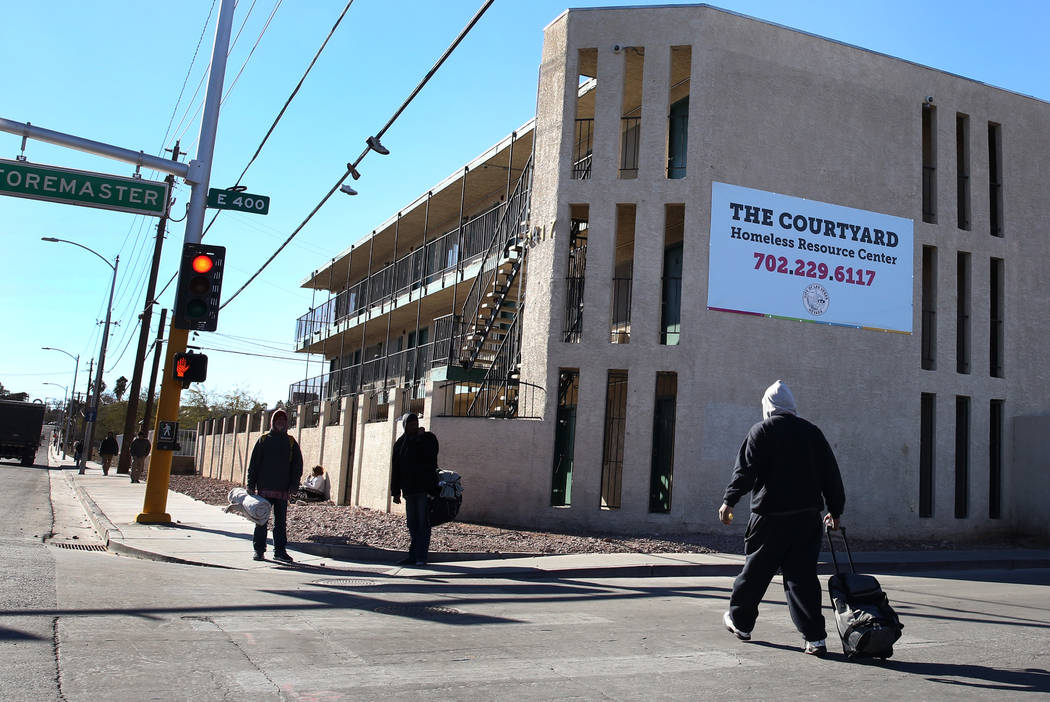Pedestrians walk past the city of Las Vegas' homeless courtyard on Tuesday, Jan. 22, 2019. (Biz ...