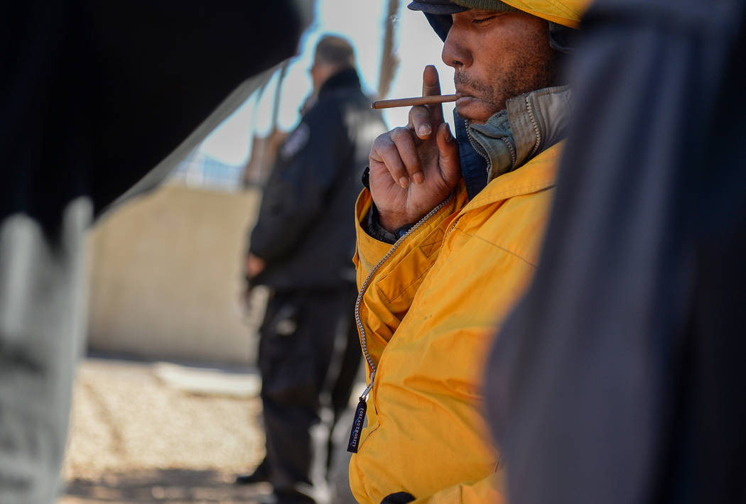 Jonathan Dickerson sits and smokes at the city of Las Vegas' homeless courtyard in Las Vegas, T ...