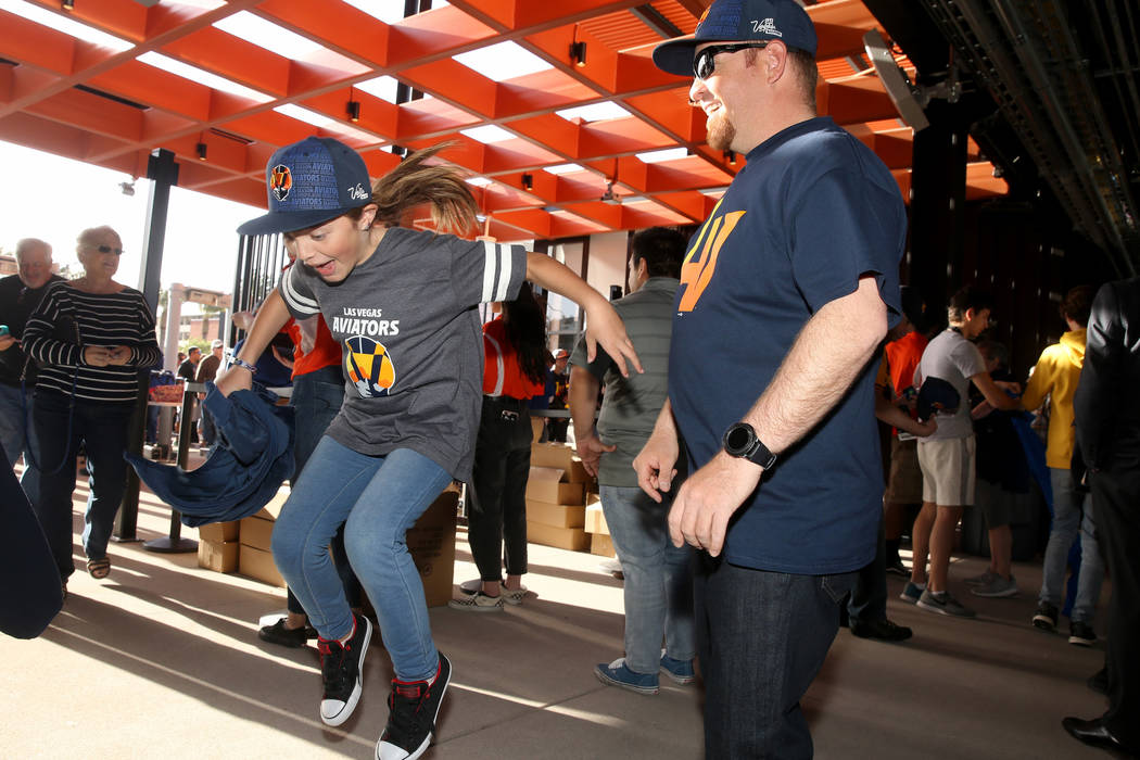 Robert Gallegos, 35, and his daughter Zariah, 10, celebrate entering the ballpark for the first ...