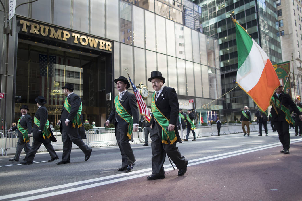 Participants march up Fifth Avenue past Trump tower during the St. Patrick's Day Parade, Saturd ...