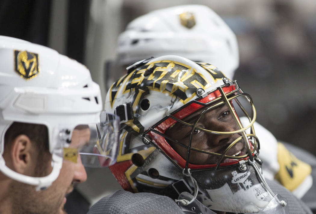 Golden Knights goaltender Malcolm Subban (30) jokes around with teammate Ryan Carpenter (40) du ...