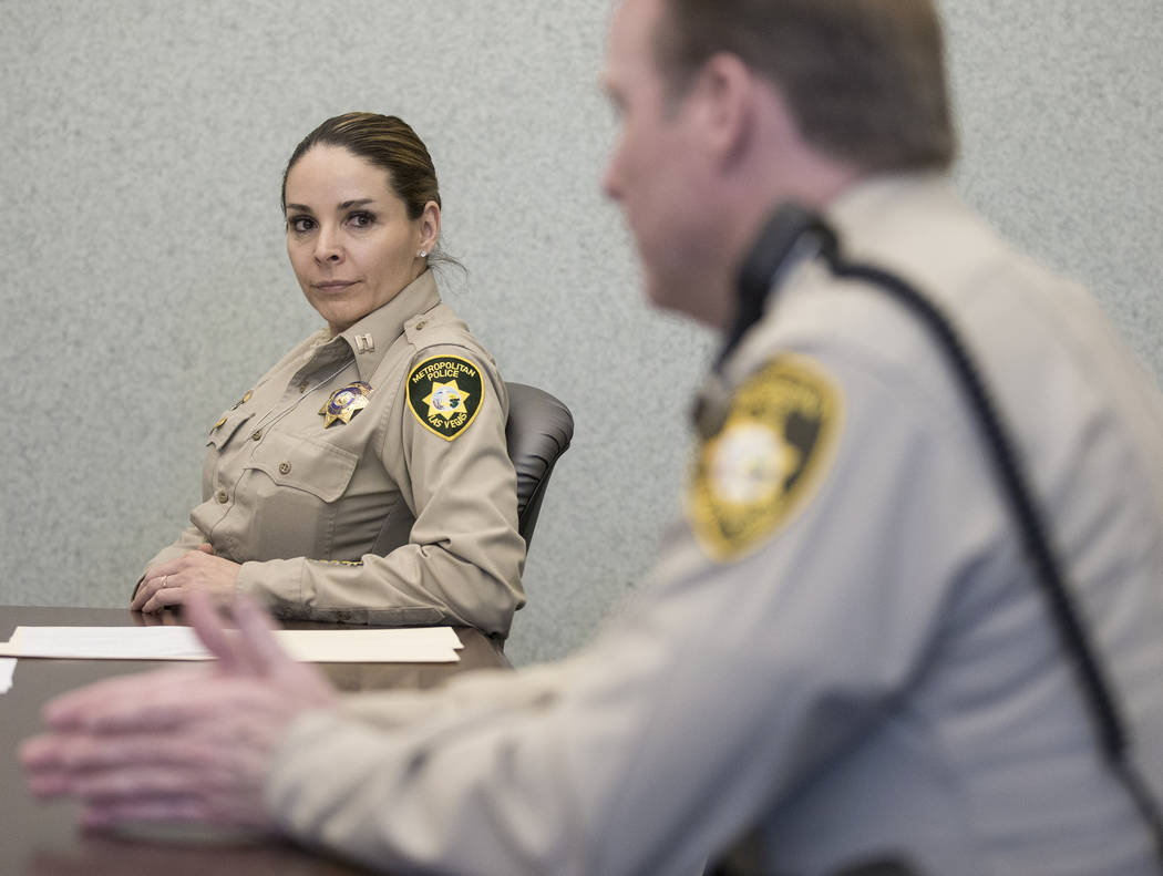 Metropolitan Police Department Capt. Sasha Larkin, left, listens to Metropolitan Police Departm ...