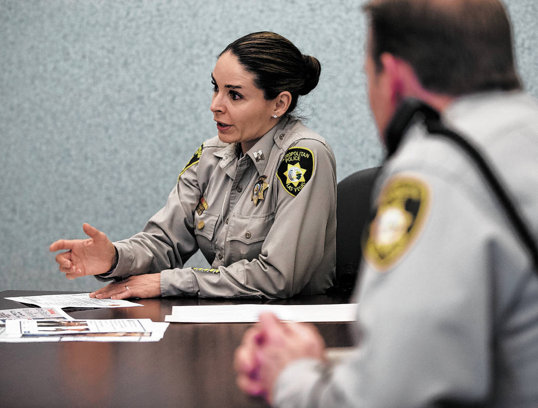 Metropolitan Police Department Capt. Sasha Larkin, left, discusses the issue of stolen guns in ...