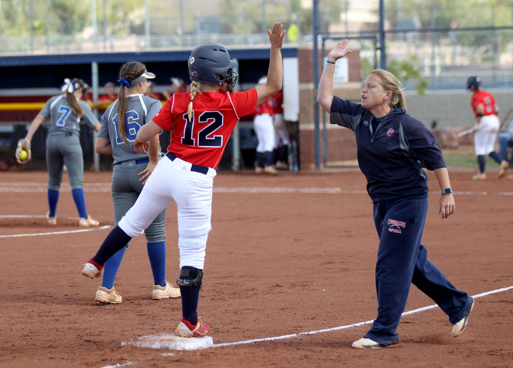 Coronado baserunner Paige Sinicki (12) high-fives head coach Melissa Krueger after hitting a tr ...