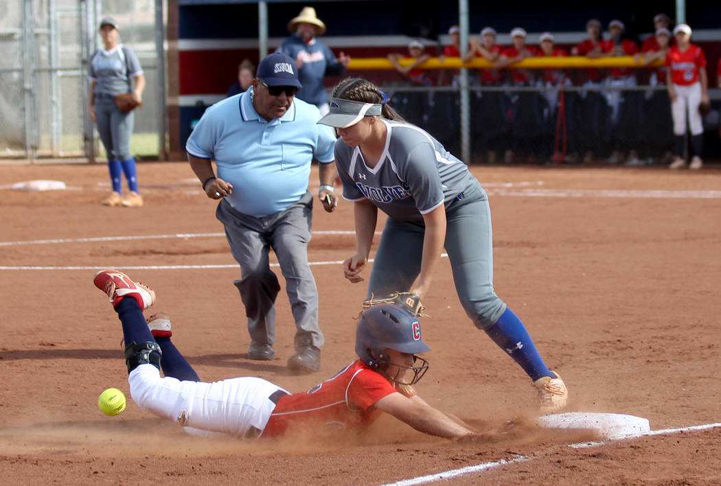 Coronado baserunner Paige Sinicki (12) slides safely into third base as Basic Madison Berg (16) ...