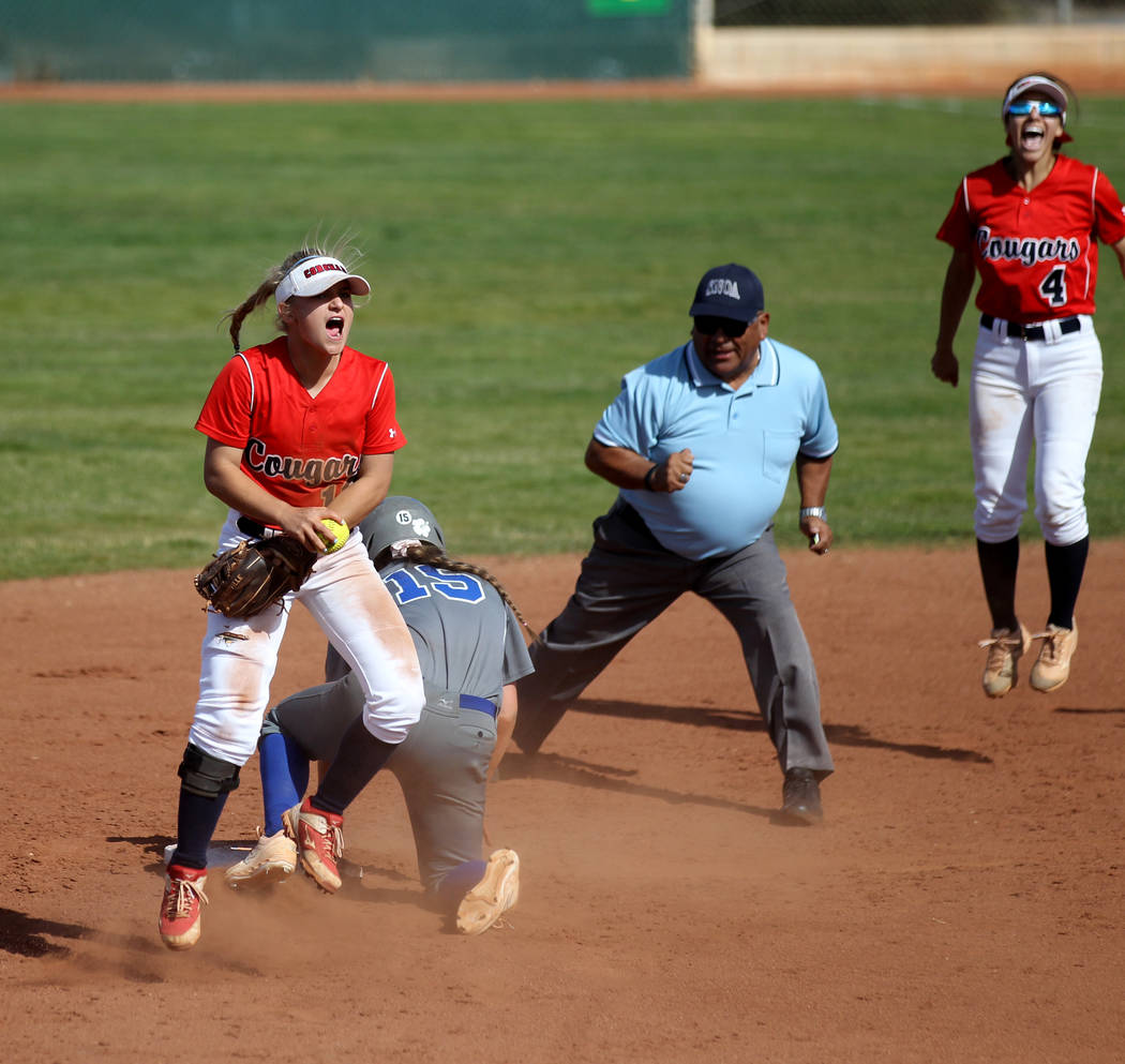 Coronado shortstop Paige Sinicki (12) and Aleah Baldonado (4) celebrate after Sinicki tagged ou ...