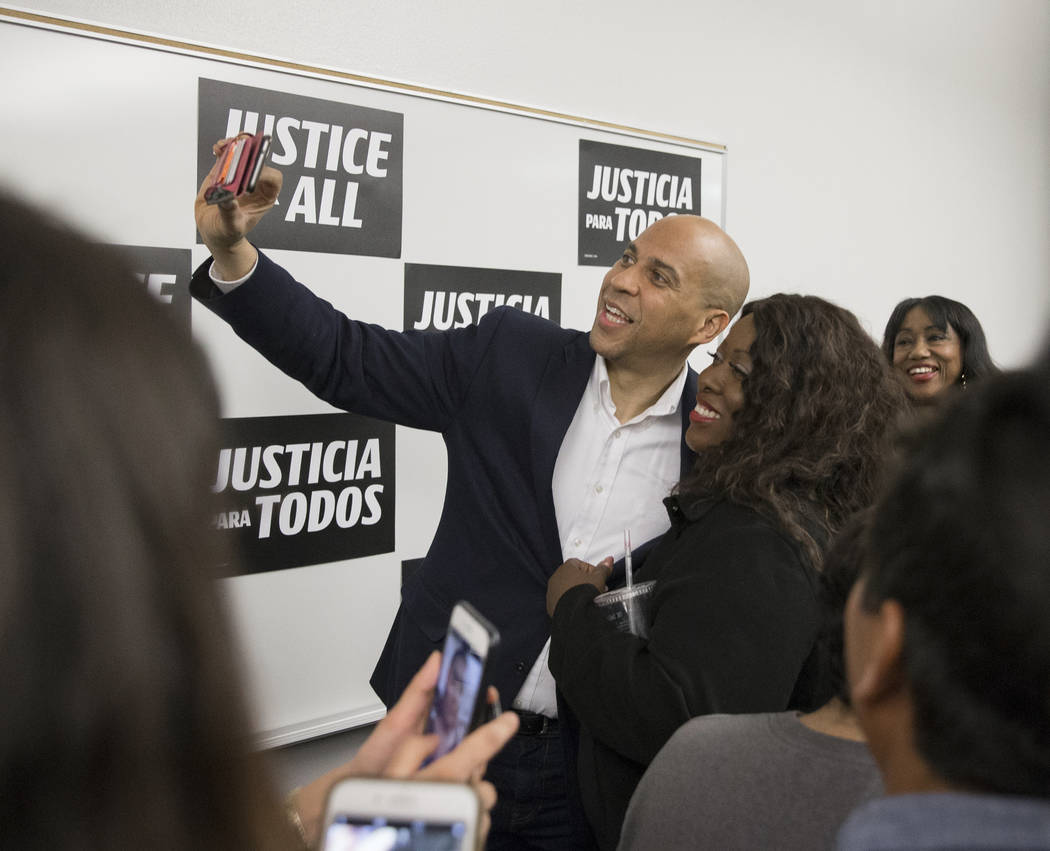 Democratic presidential candidate Sen. Cory Booker, left, D-N.J., takes a photo with Shannon Ch ...