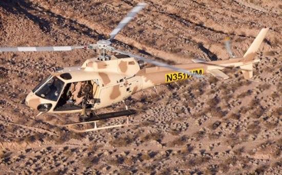 A helicopter flies over the Gunship Helicopters site in Sandy Valley, south of Las Vegas. (Guns ...
