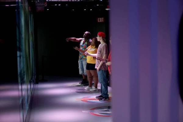 Guests play an interactive game at the Avengers S.T.A.T.I.O.N exhibit at Treasure Island hotel- ...