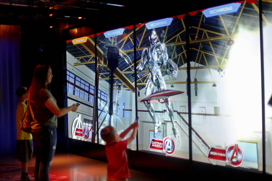 Guests play an interactive game at the Avengers S.T.A.T.I.O.N exhibit at Treasure Island hotel- ...