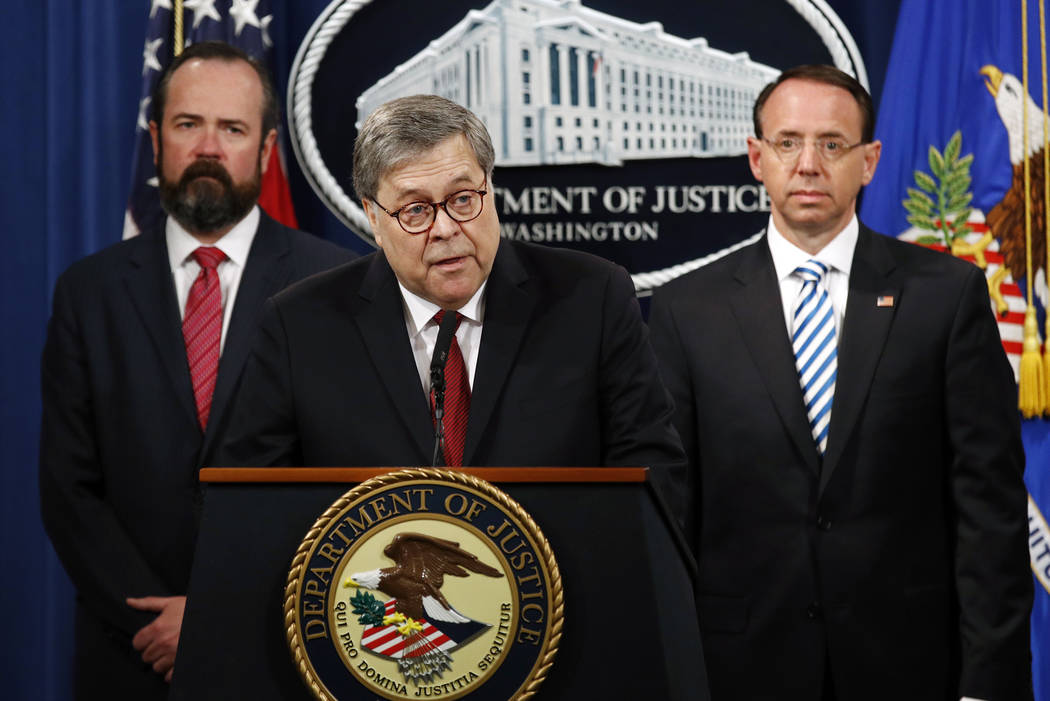 Attorney General William Barr, center, speaks alongside Deputy Attorney General Rod Rosenstein, ...