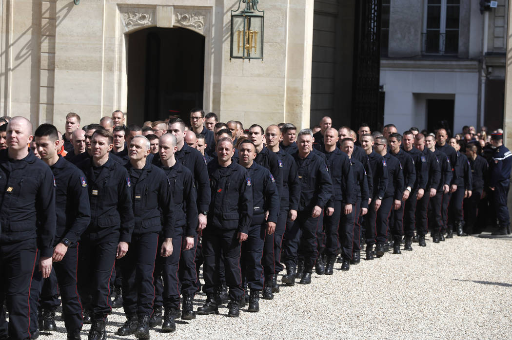 Emergency service personnel walk at the Elysee Palace in Paris after a meeting with French Pres ...