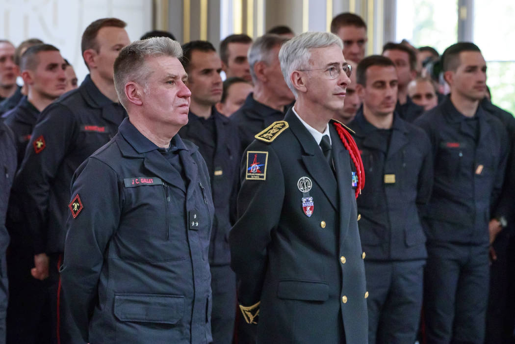 French General Jean-Claude Gallet, left, and Paris Prefect Didier Lallement listen to French Pr ...