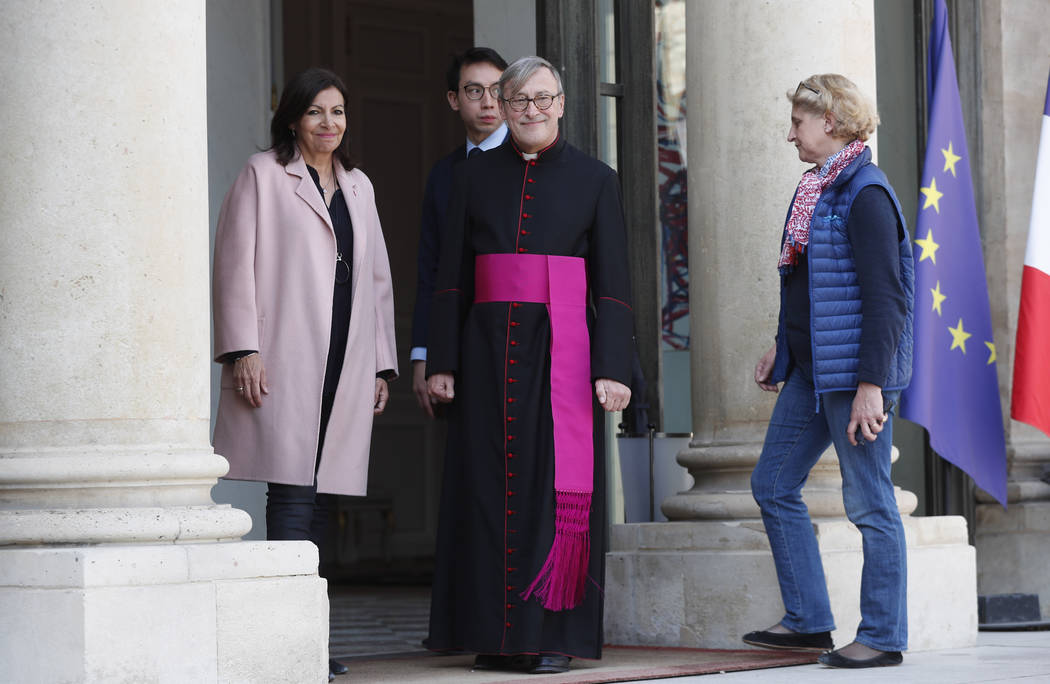 Rector of the Notre Dame Patrick Chauvet, center, stands at the Elysee Palace in Paris prior to ...