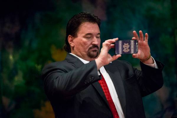 Nevada Republican Party Chairman Michael McDonald uses his phone during a campaign rally for Re ...