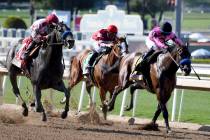 Jockey Mike Smith, left, riding Roadster wins the Santa Anita Derby (Grade 1) race at Santa Ani ...