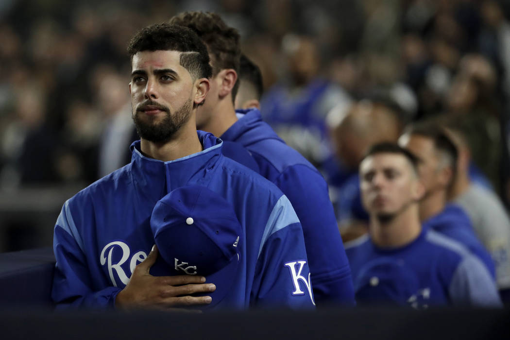 Kansas City Royals players listen to "God Bless America" during the seventh-inning st ...