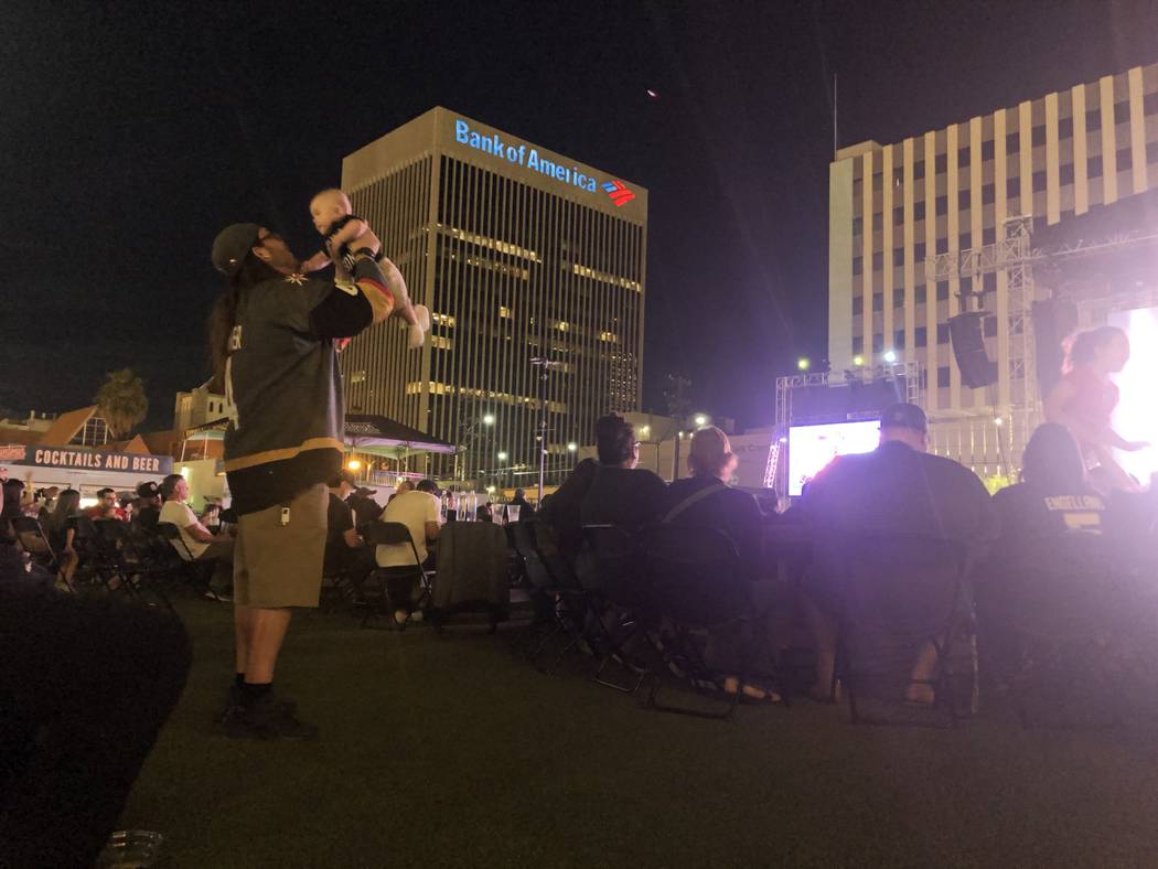 A Las Vegas Golden Knights fan lifts a baby in the air on Thursday, April 18, 2019, at the Down ...