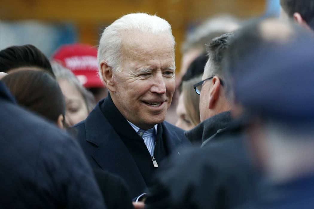 Former vice president Joe Biden talks with officials after speaking at a rally in support of st ...