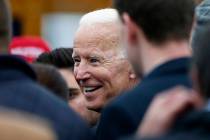 Former vice president Joe Biden talks with officials after speaking at a rally in support of st ...