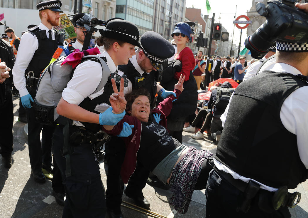 Police arrest protestors at Oxford Circus in London, Friday, April 19, 2019. The environmental ...