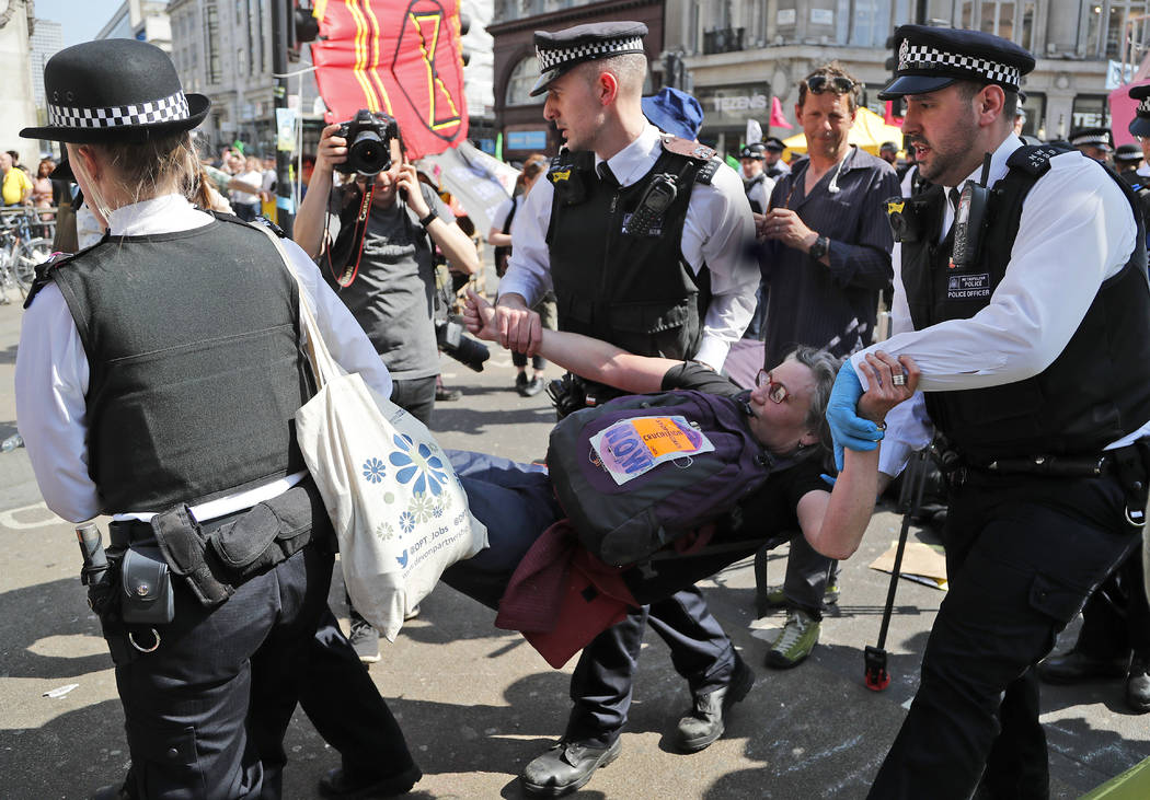 Police arrest protestors at Oxford Circus in London, Friday, April 19, 2019. The group Extincti ...