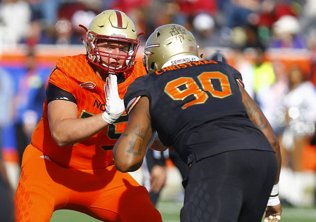 North offensive guard Chris Lindstrom of Boston College (75) blocks out South defensive tackle ...