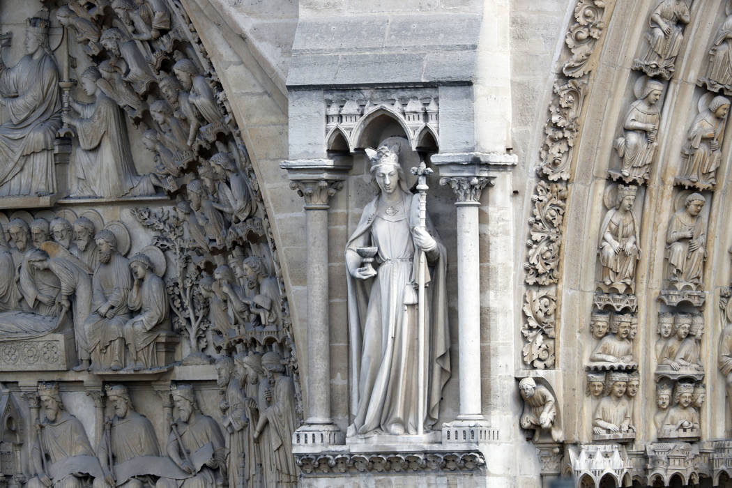 A statue is pictured just outside Notre Dame cathedral Wednesday, April 17, 2019 in Paris. Notr ...