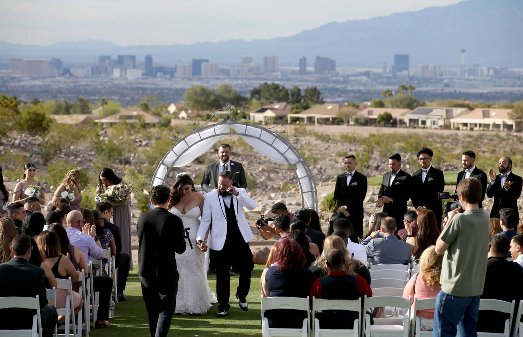 Kimberly and William King walk down the isle during their wedding ceremony at the Revere Golf C ...