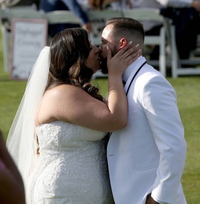 Kimberly and William King kiss after their wedding ceremony at the Revere Golf Club in Henderso ...