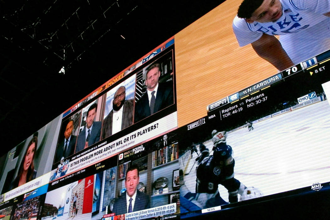 Giant video screens inside the sports betting lounge at the Tropicana casino in Atlantic City. ...