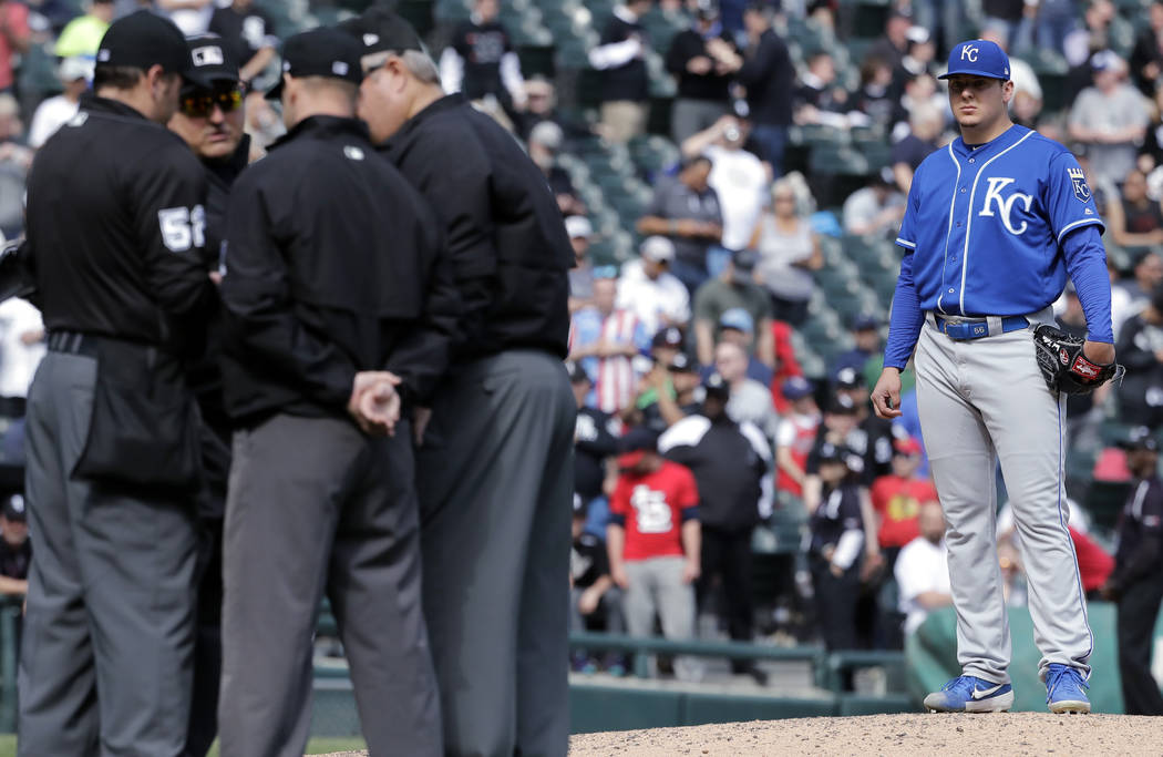 Kansas City Royals starting pitcher Brad Keller, right, looks at the umpires after Chicago Whit ...