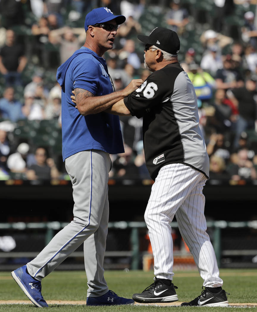 Kansas City Royals bench coach Dale Sveum, left, and Chicago White Sox manager Rick Renteria sh ...