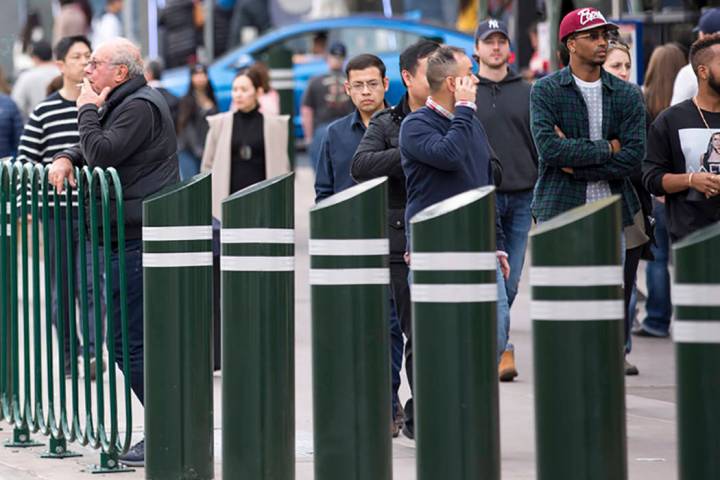 People walk past safety bollards on the Vegas Strip on Tuesday, Jan. 2, 2018. (Las Vegas Review ...