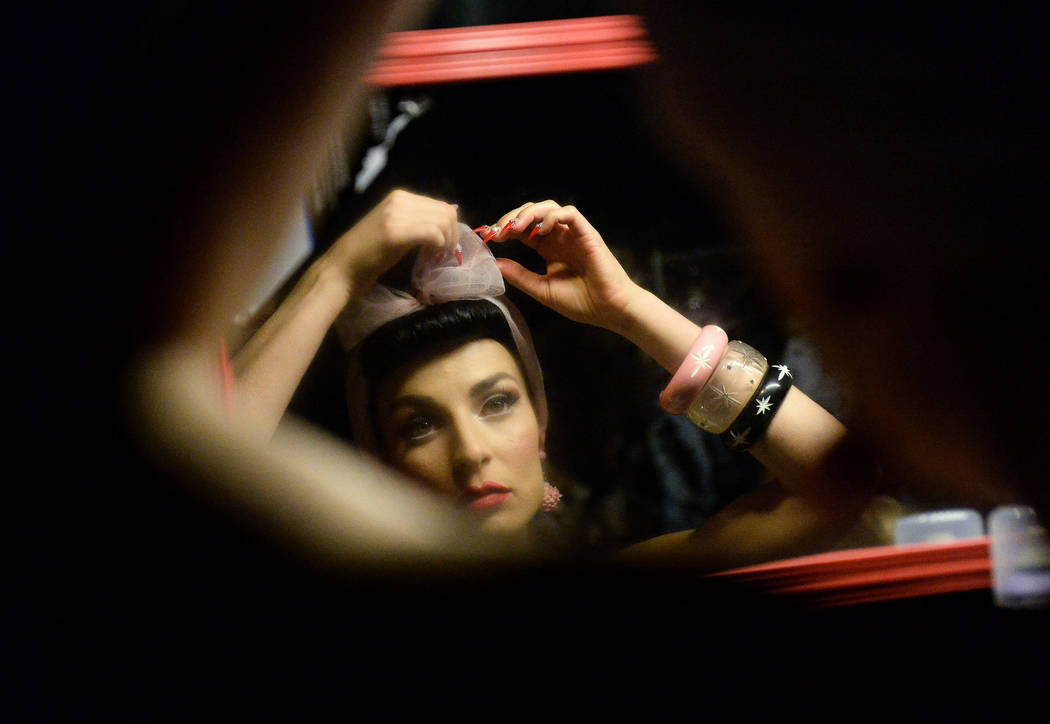 Lucy Luxe fixes a bow in her hair backstage of the fashion show at The Orleans during the Viva ...