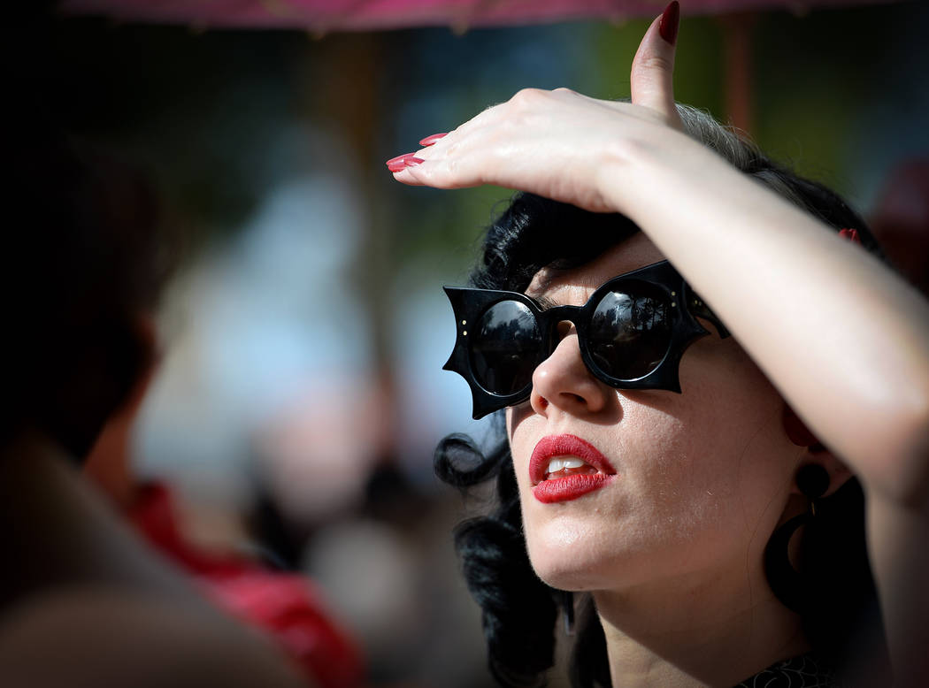 Jess Wehrle from N.Y. watches a performance at the pool at The Orleans during the Viva Las Vega ...