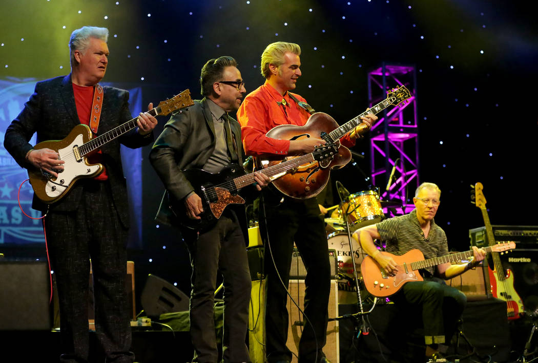 Guitarists Mark Gamsjager, left, Chris Casello, Mitch Polzak and Jim Heath, sitting, pack the s ...