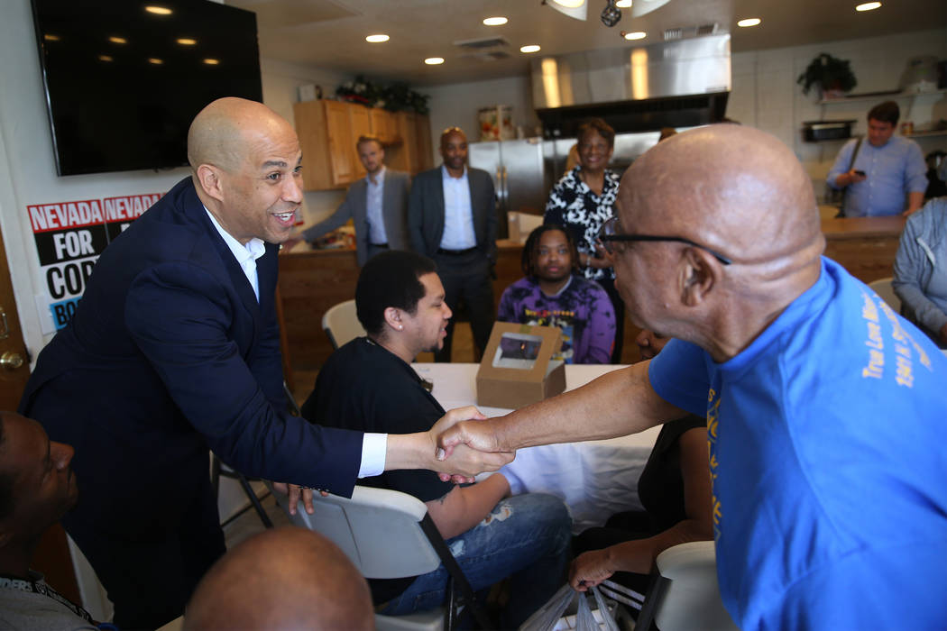 Democratic presidential candidate Sen. Cory Booker, D-N.J., left, meets the Rev. James Kelly du ...