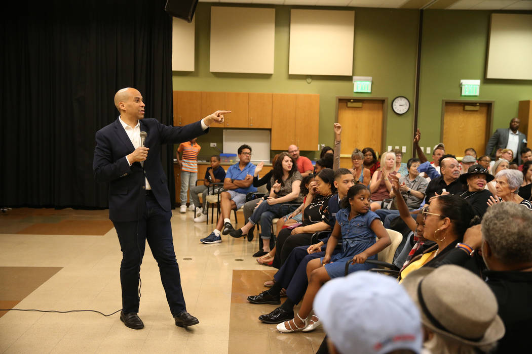 Democratic presidential candidate Sen. Cory Booker, D-N.J., left, speaks during an event at the ...