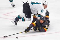 Golden Knights right wing Ryan Reaves (75) is taken to the ice by San Jose Sharks defenseman Ju ...